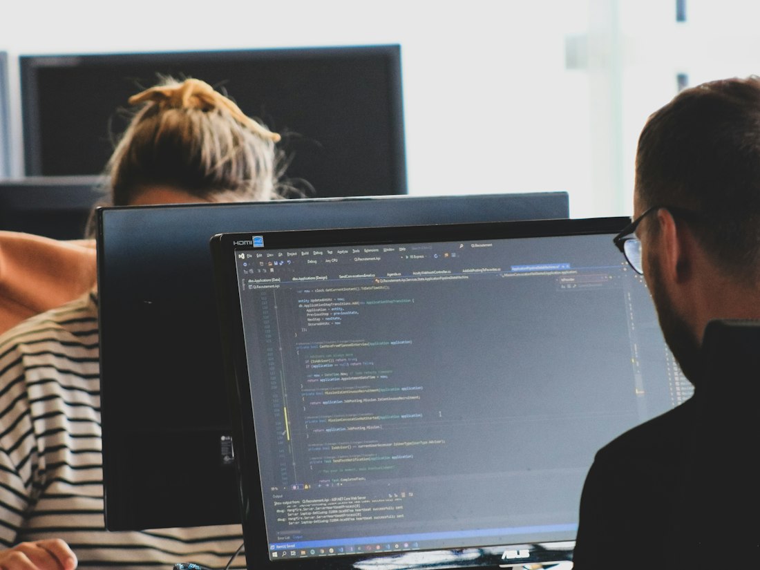 Developers working on code at their workstations